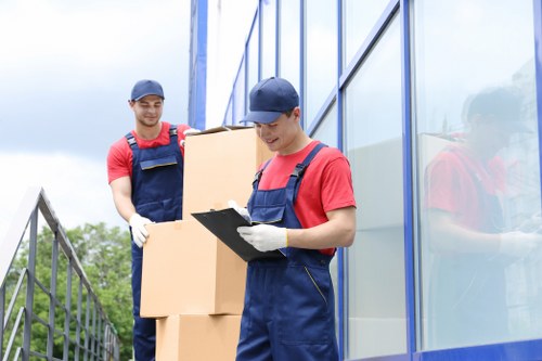 Local moving team handling boxes at a Dagenham property with access challenges