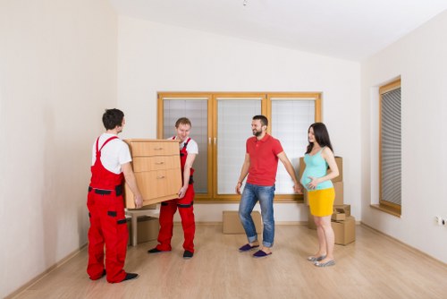 House movers carrying furniture from a residential property in Dagenham