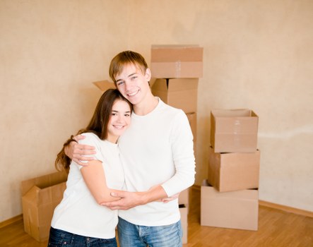 Family preparing boxes for a home move in Dagenham