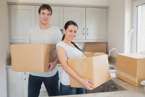 Professional office movers handling desks and storage items during a Dagenham relocation
